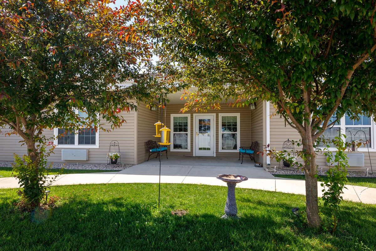 A cozy house with a well-maintained front yard and a birdbath.