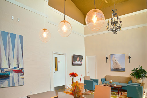 A stylish and modern living space with unique lighting fixtures and comfortable seating.
