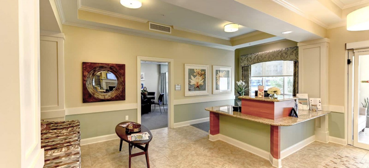 A well-decorated reception area with comfortable seating and artwork on the walls.