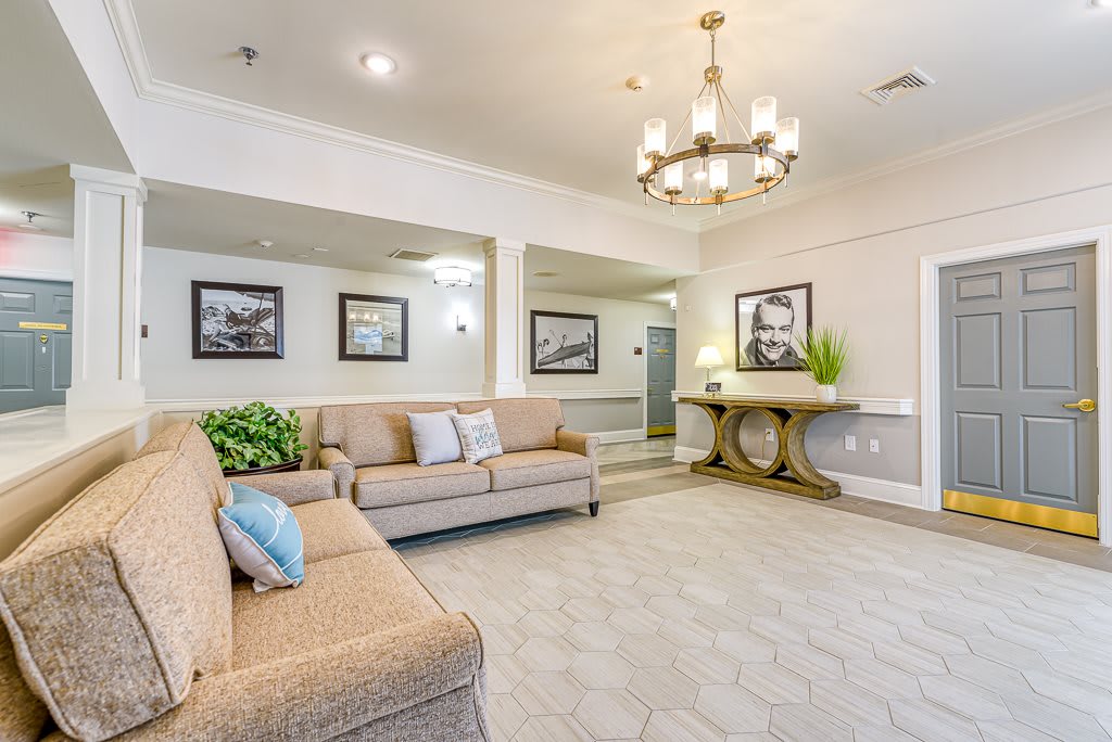 A spacious and elegantly designed living room with cozy sofas, a chandelier, and decorative elements.