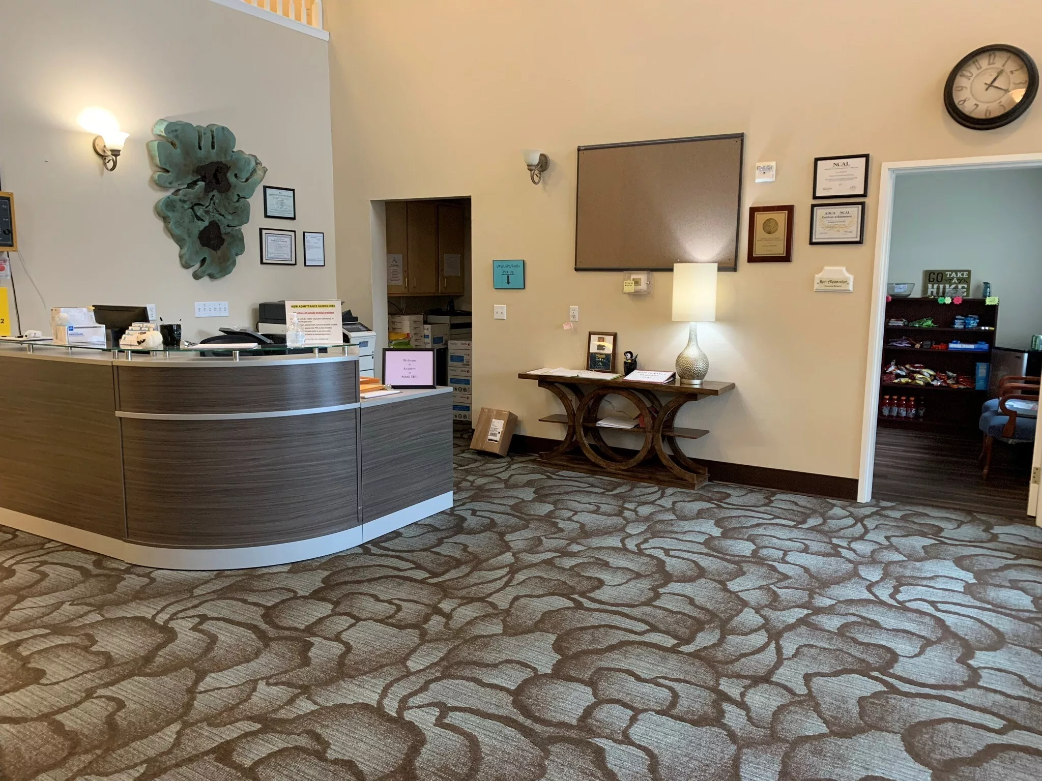 A reception area with a front desk and decorative elements.