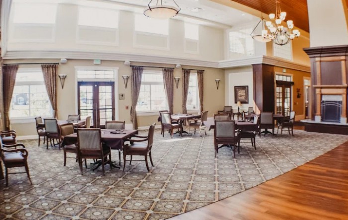 Spacious dining area with elegant furnishings and natural lighting.
