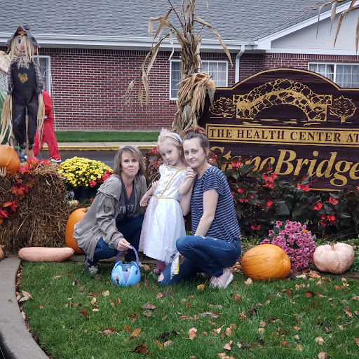 A family gathering during the autumn season, surrounded by festive decorations and pumpkins.