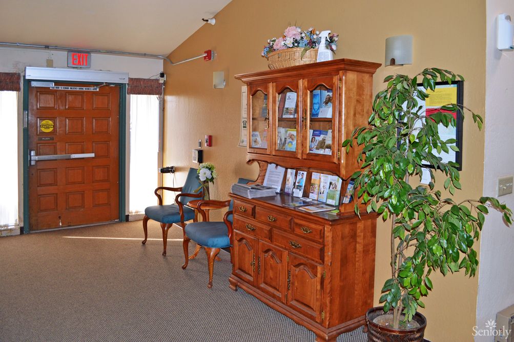A cozy hallway with wooden furniture and decorative elements.