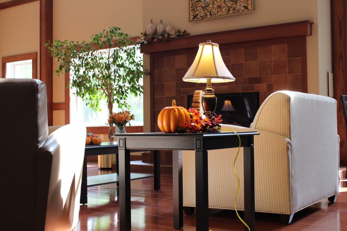 Cozy living room with autumn decorations and natural lighting.