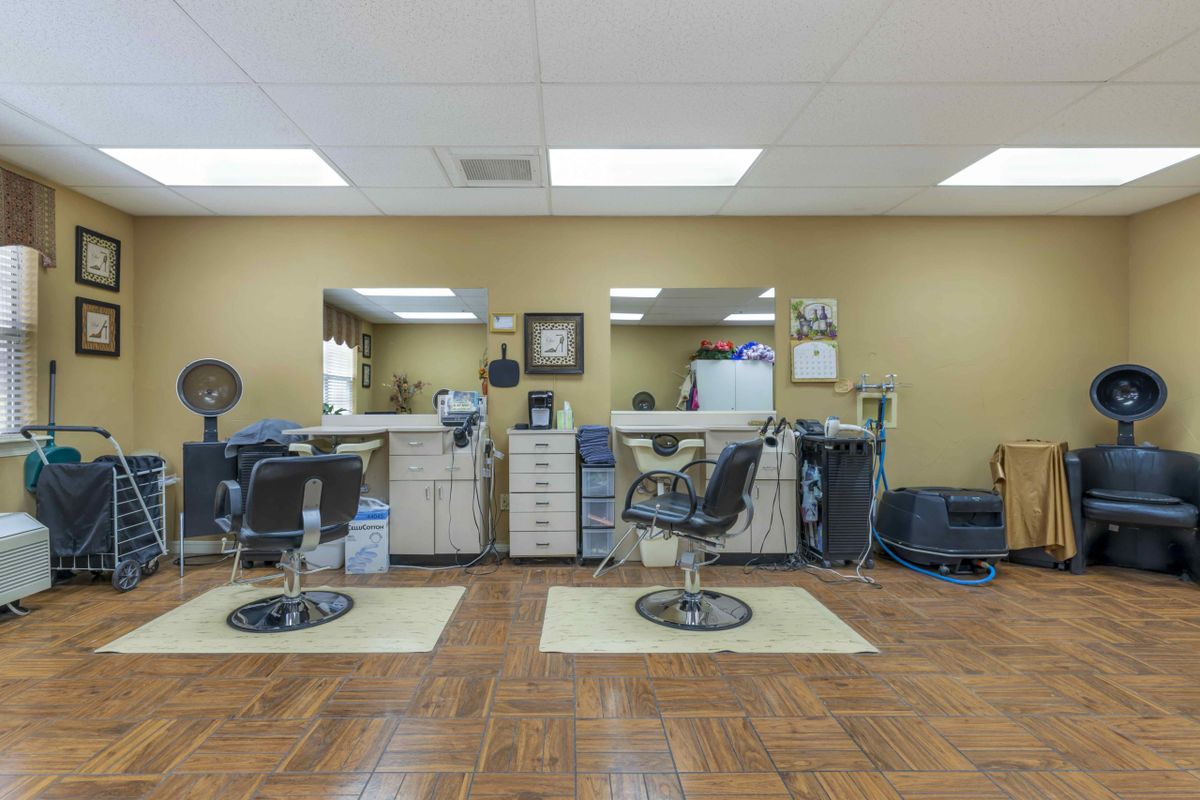 Interior of a barbershop with styling chairs and mirrors.