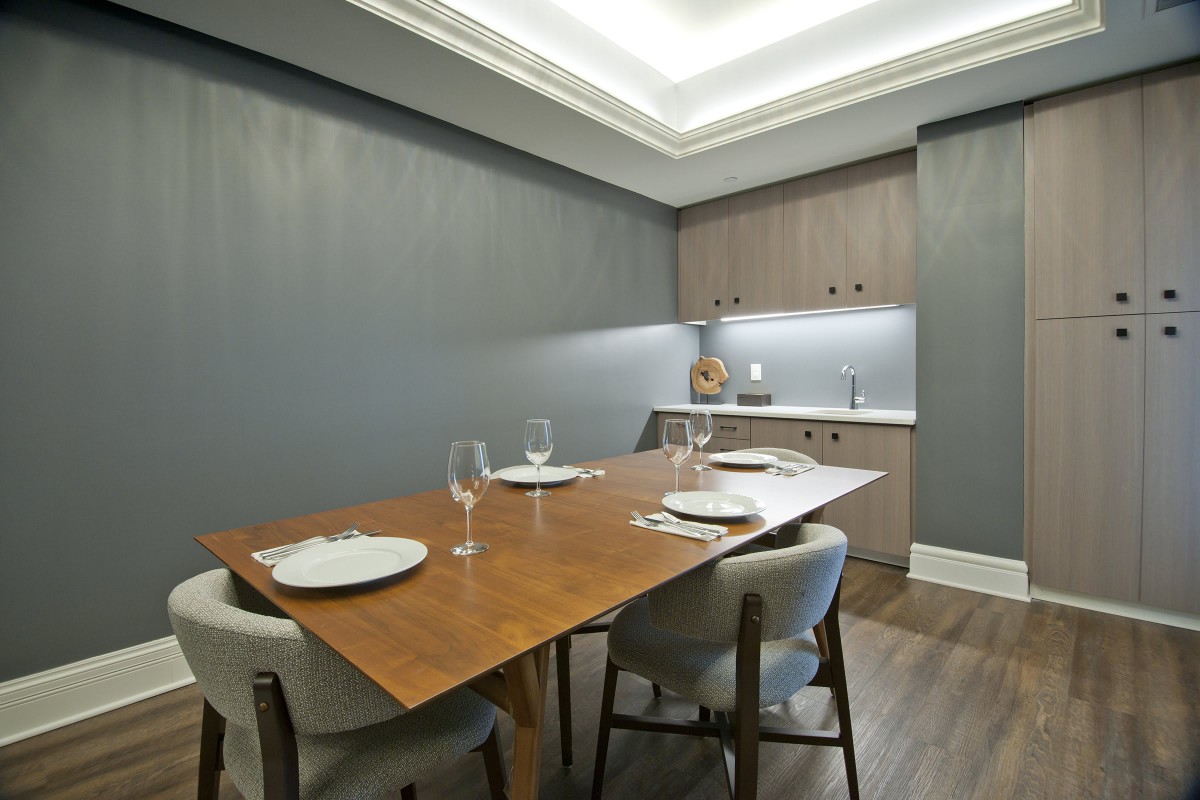 A modern dining room with a sleek wooden table and minimalist decor.