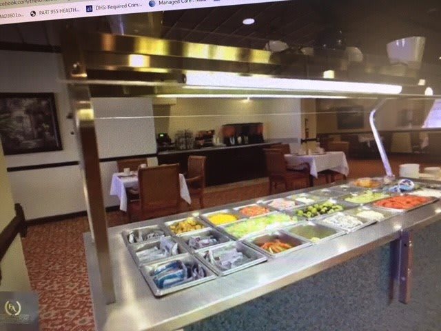 A well-lit buffet area in a restaurant with a variety of food options.
