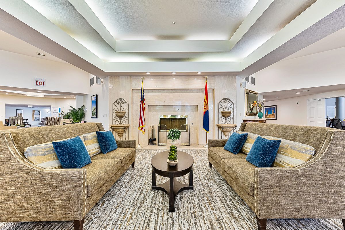 A modern living room with sofas, a central table, and a fireplace.