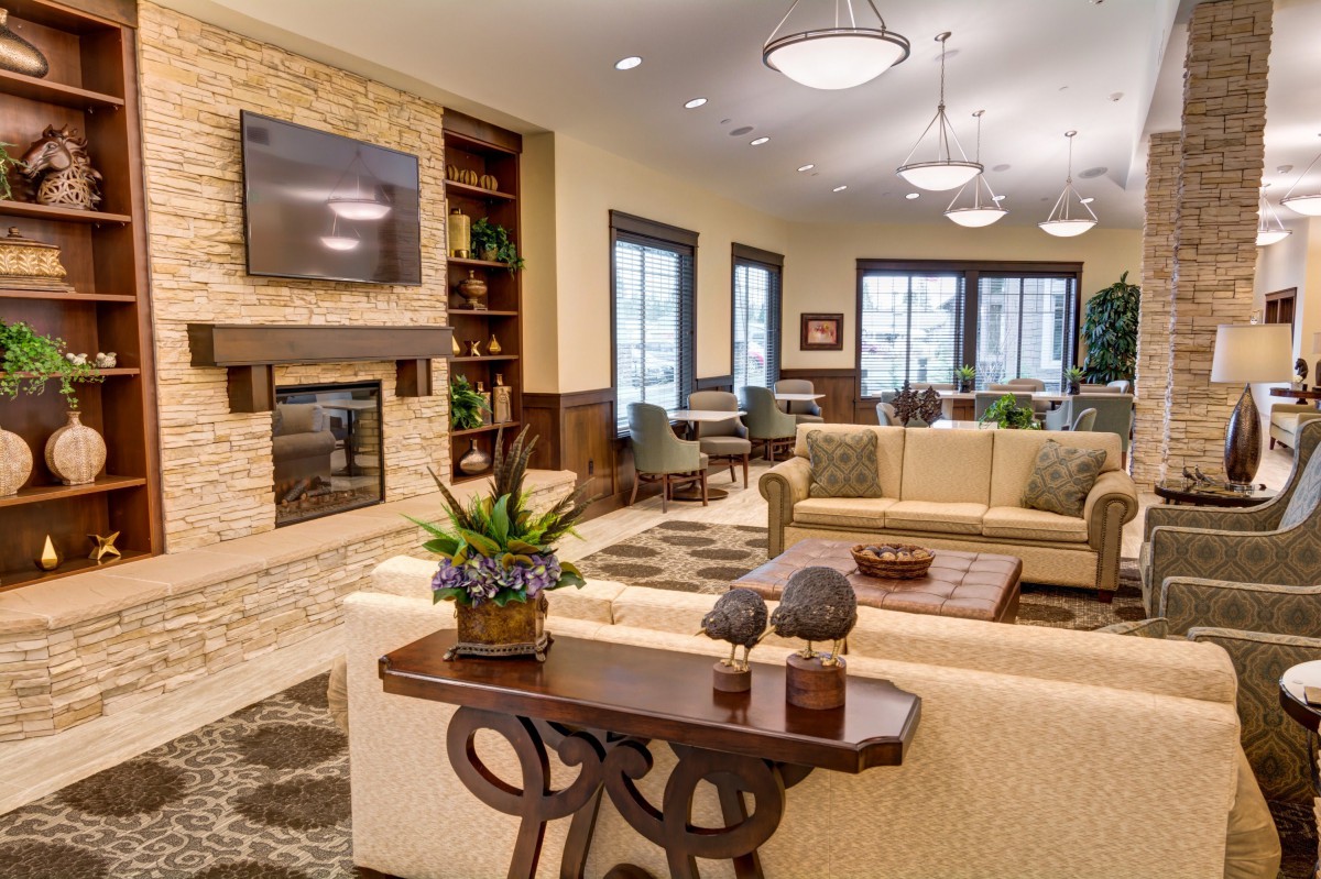 A modern living room featuring comfortable sofas, a fireplace, and elegant decor.