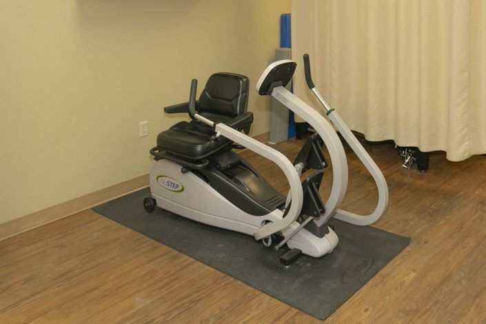 A seated exercise machine in a gym setting.