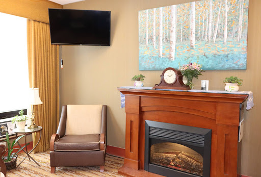 A cozy living room featuring a modern fireplace and comfortable seating.