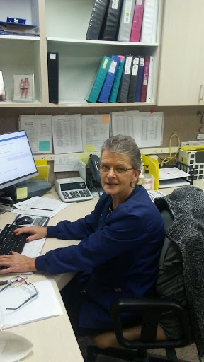 A woman working at her desk in an office environment.