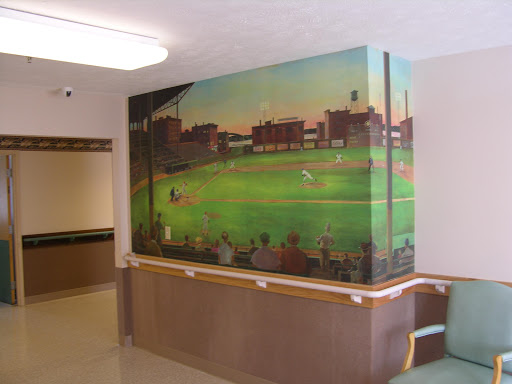 A vibrant mural depicting a baseball scene, enhancing the interior of a public space.