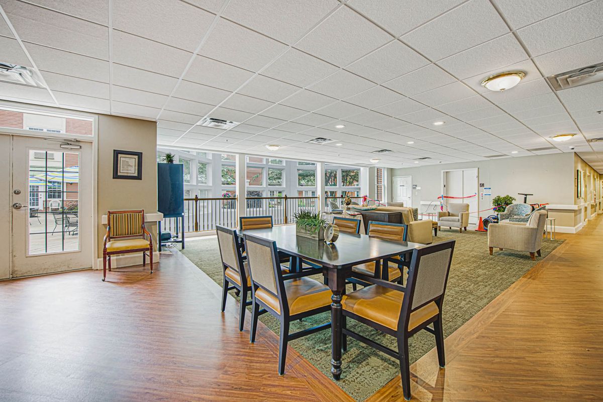 A spacious and modern lounge area with tables and chairs.