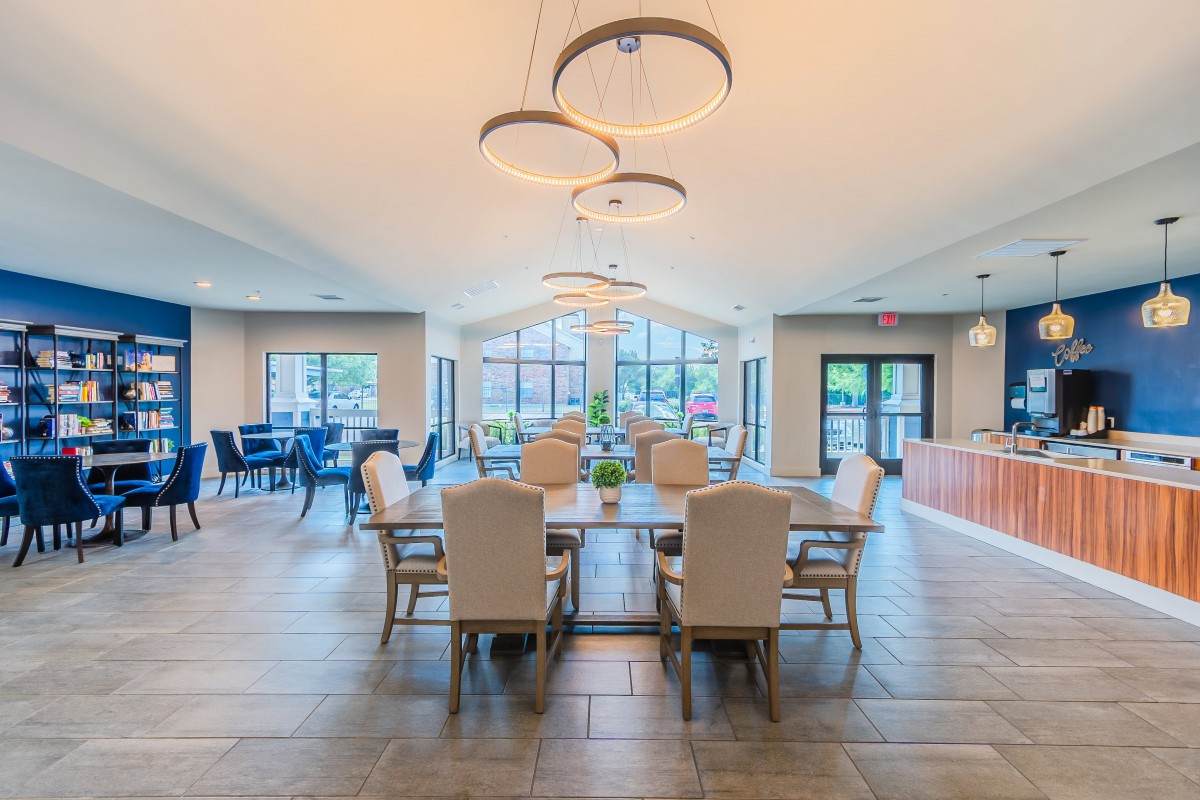 A modern and spacious dining area with elegant lighting and comfortable seating.