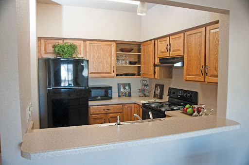 A modern kitchen featuring wooden cabinetry and essential appliances.