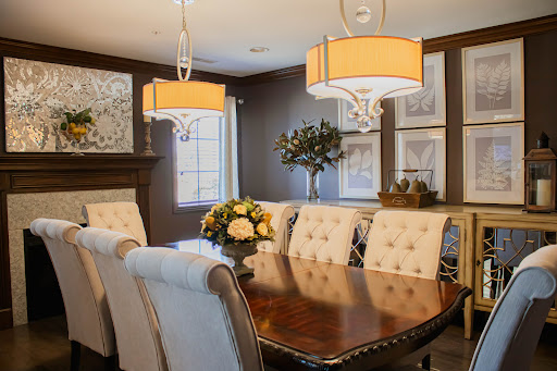 A beautifully designed dining room featuring elegant furniture and warm lighting.