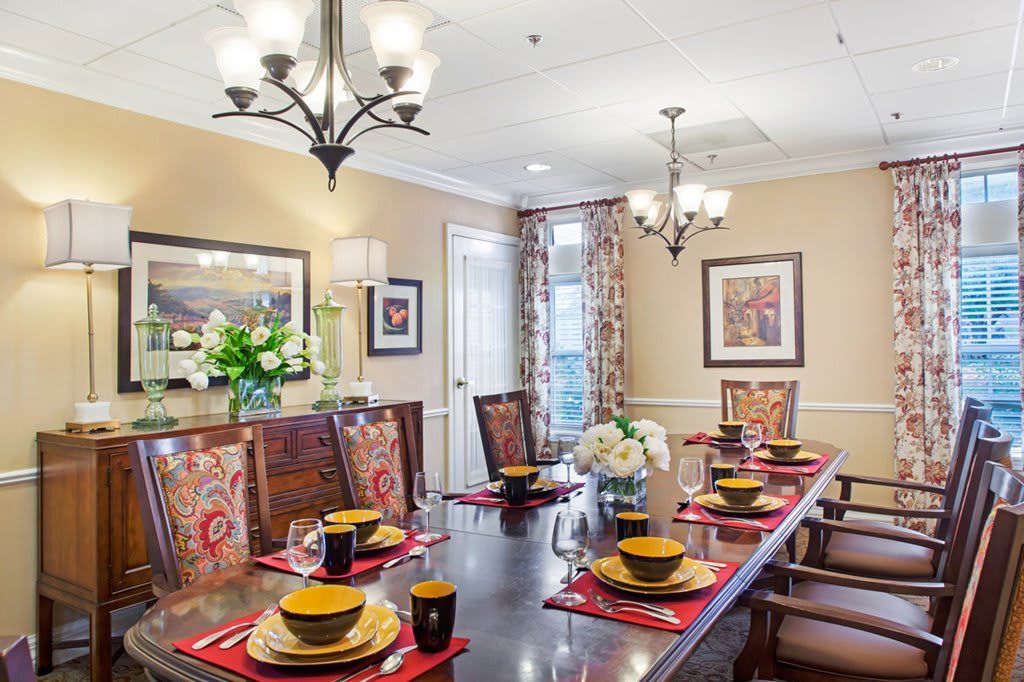A well-decorated dining room with an elegant table setting and ambient lighting.