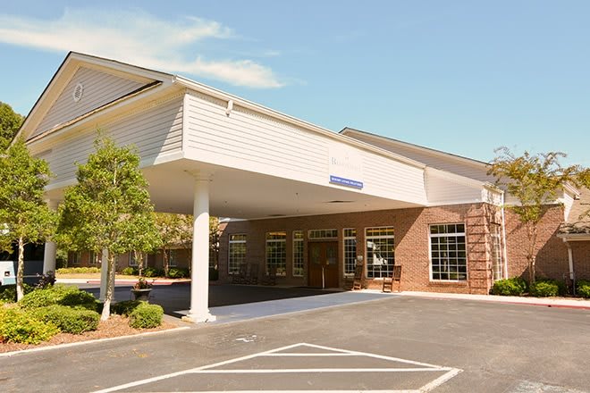 The entrance of a hospital building on a sunny day.