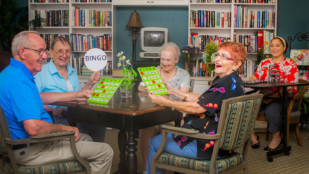 A group of senior citizens enjoying a game of bingo together in a cozy room.