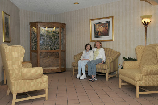 A cozy living room seating area featuring a couple relaxing on a couch.