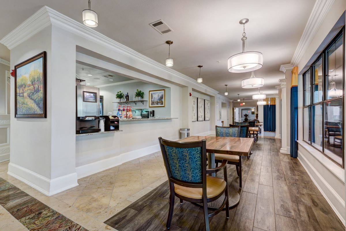 A modern lobby with a reception desk, seating area, and elegant lighting fixtures.