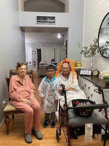 A heartwarming moment with a child and two elderly individuals in a comfortable home setting.