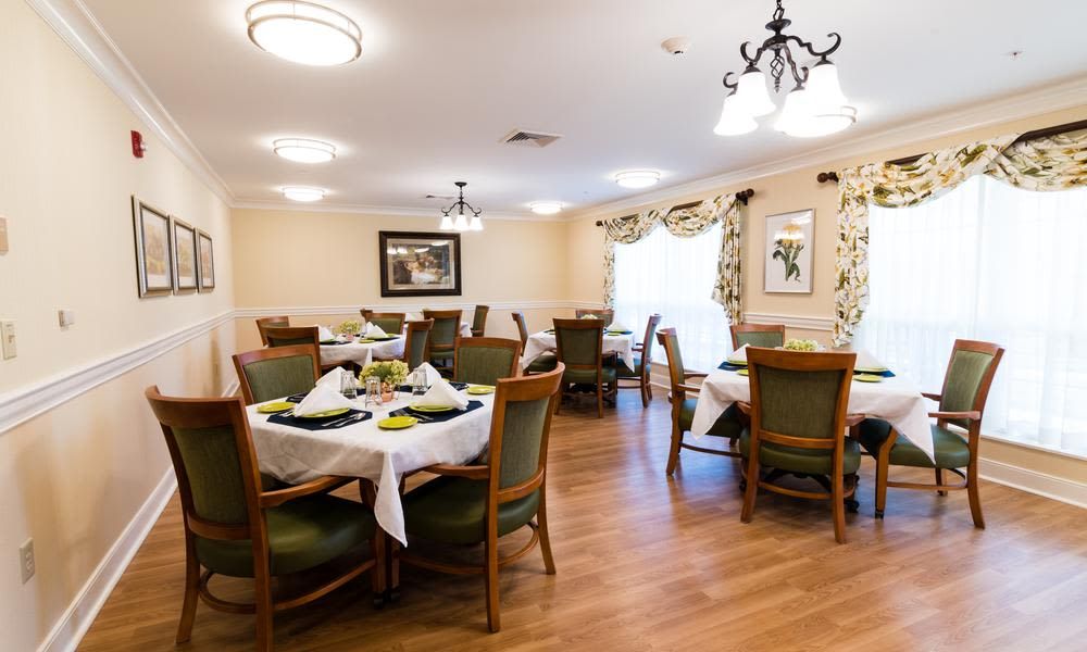 A well-decorated dining room with elegantly set tables and comfortable chairs.