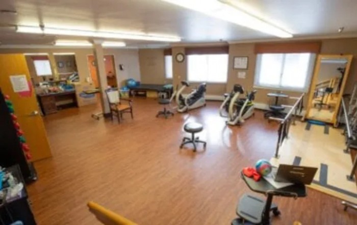 A spacious gym with exercise bikes and fitness equipment.
