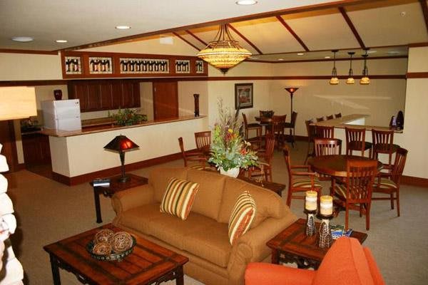 A cozy living room with comfortable seating and warm wooden decor.