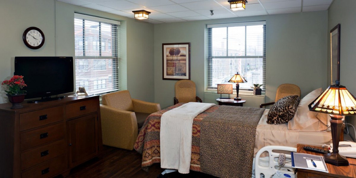 A cozy hospital room with a bed, comfortable chairs, and large windows letting in natural light.