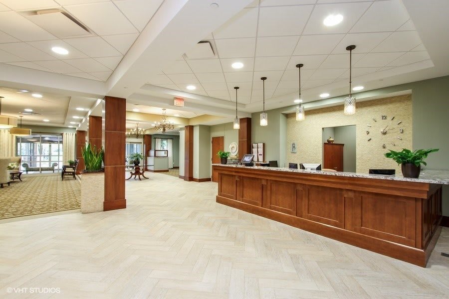 A modern reception area with wooden furniture and stylish lighting.