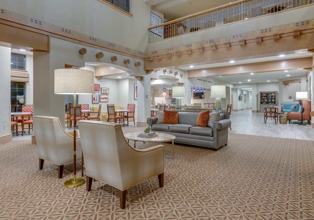 Spacious hotel lobby with comfortable seating and elegant decor.