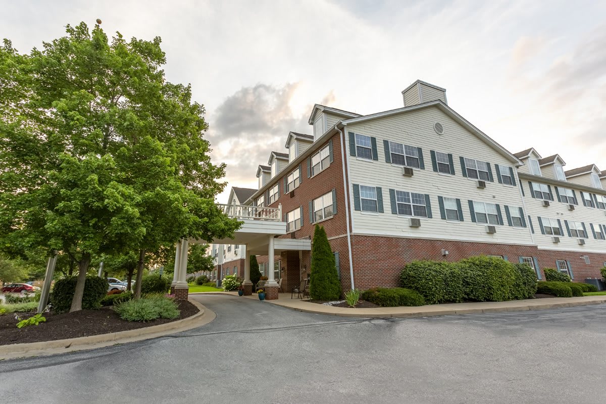 Exterior view of a hotel with trees and landscaping.