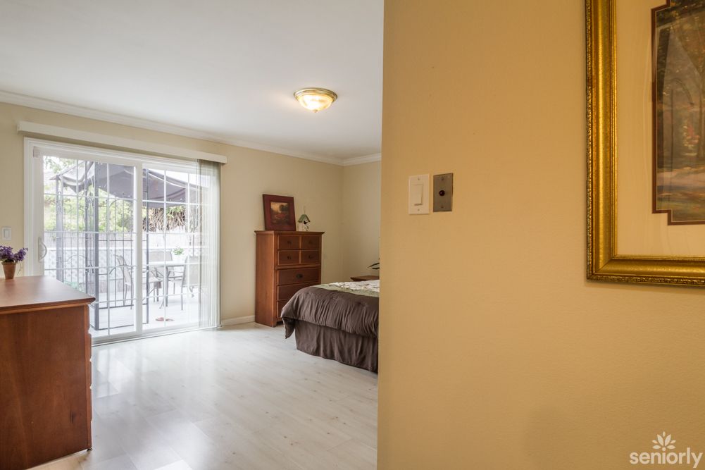A spacious bedroom with sliding doors allowing natural light to fill the room.