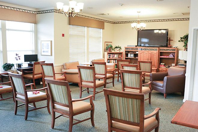A cozy lounge area with arranged chairs and a television, ideal for group gatherings or relaxation.