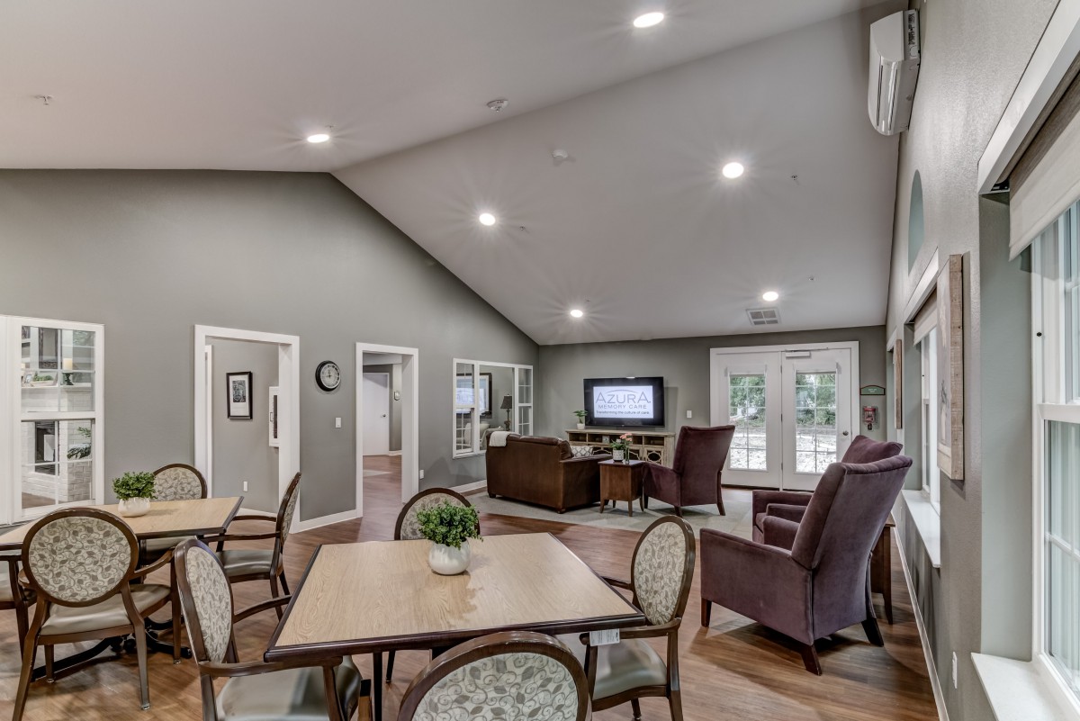 A spacious living room with modern furniture and a television.