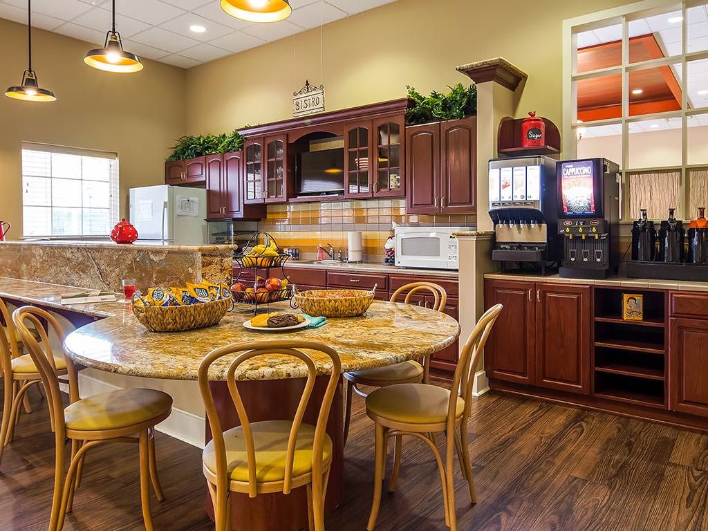 A cozy kitchen and dining area featuring wooden furniture and modern appliances.