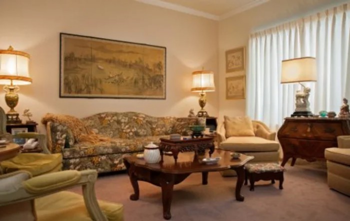 A cozy living room with vintage furniture and classic decor.