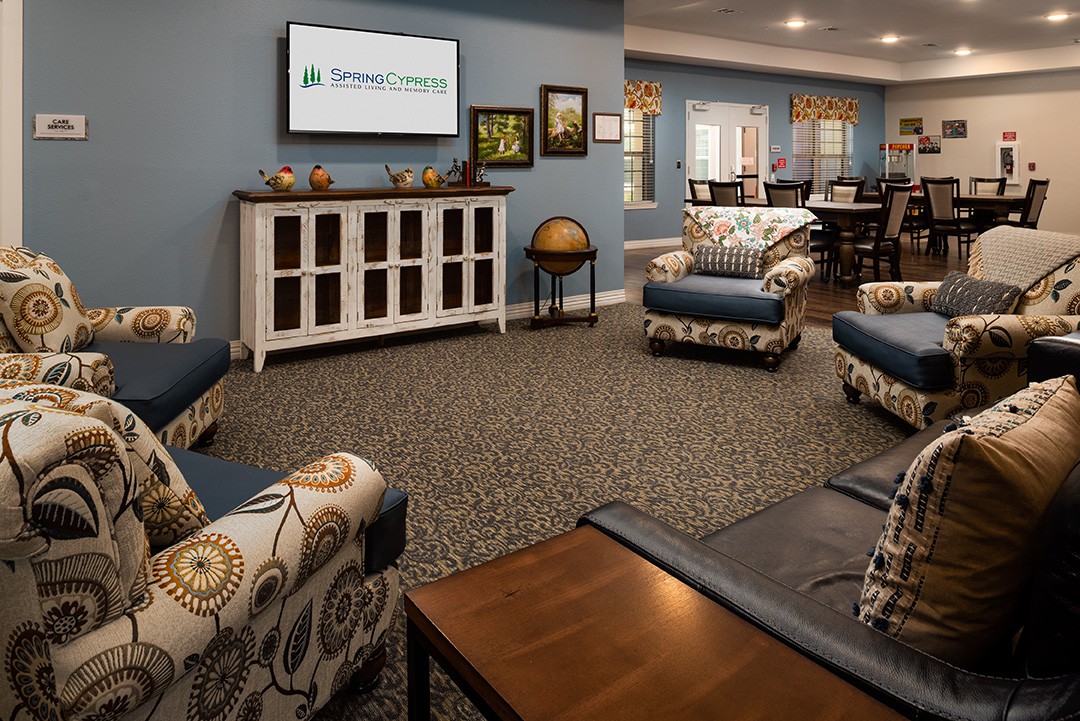 A cozy living room with comfortable seating and a TV, featuring stylish interior design.