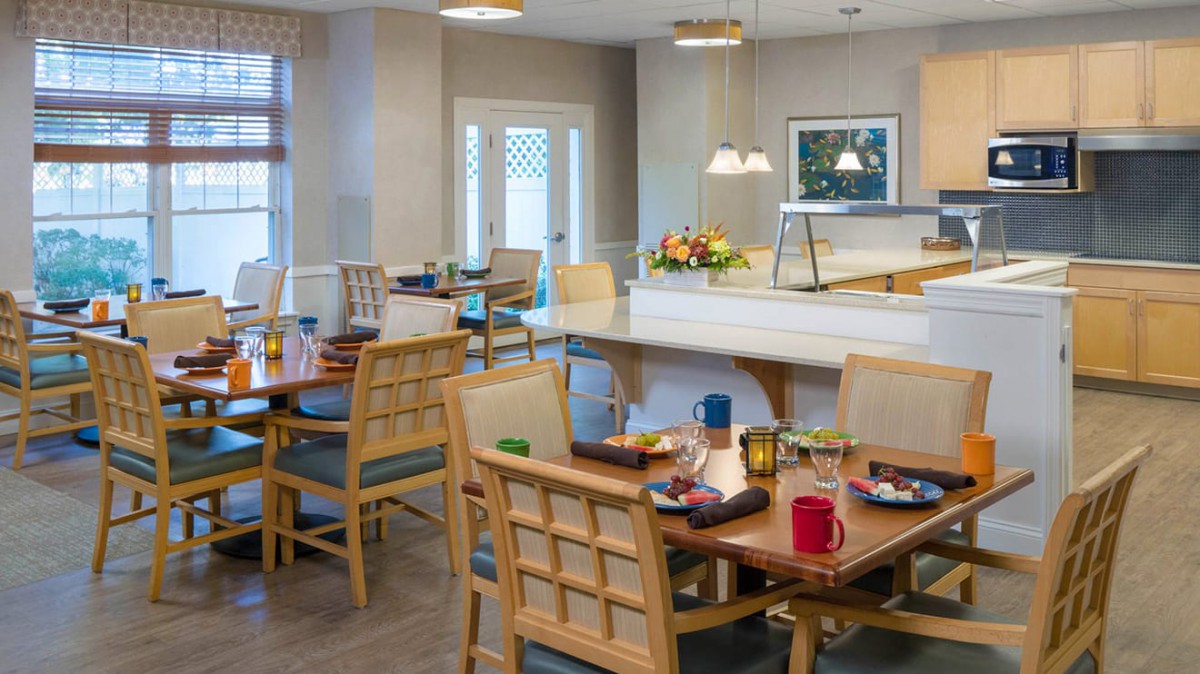 A cozy dining room with neatly arranged tables and chairs, ready for guests.
