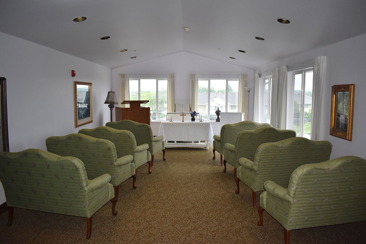 Interior view of a ceremonial room with arranged seating and natural lighting.