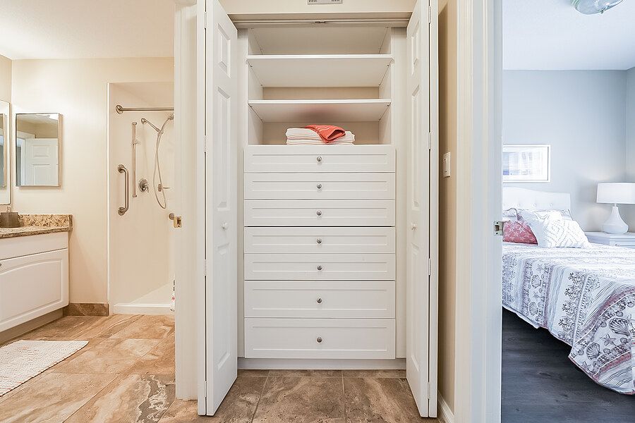 A neatly organized closet with shelves and drawers in a home interior.