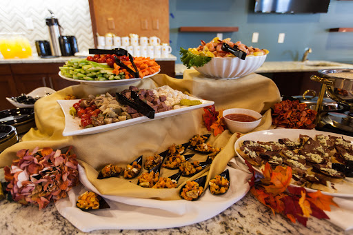 A beautifully arranged buffet featuring a variety of appetizers, salads, and sauces, perfect for any gathering.