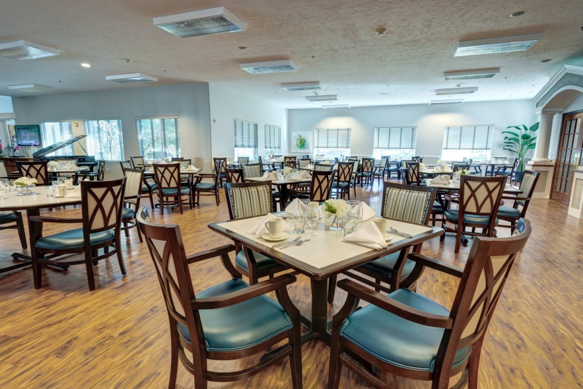An elegant dining area with neatly arranged tables and chairs, ready for guests.