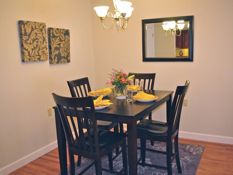 A cozy dining room with a neatly set table and warm lighting.