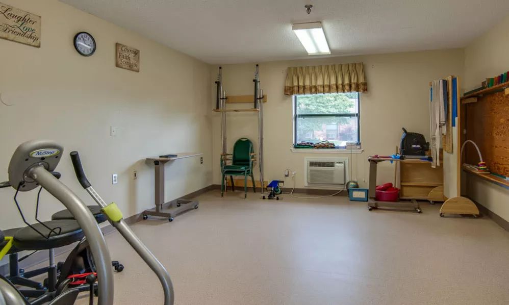 A rehabilitation room equipped with physical therapy tools and exercise equipment.