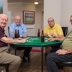 A group of friends enjoying a game of poker around a table.