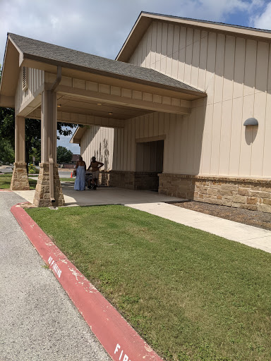 A sunny day outside a building with a welcoming entrance.